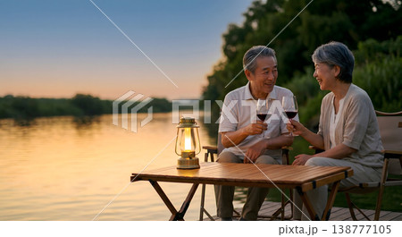 夕暮れの川辺で乾杯するシニア夫婦 豊かなセカンドライフ 絆 138777105