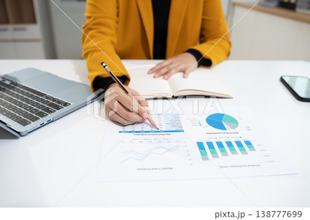 Business woman working on laptop and accounting financial report, accountant using calculator to calculate tax refund at office. 138777699