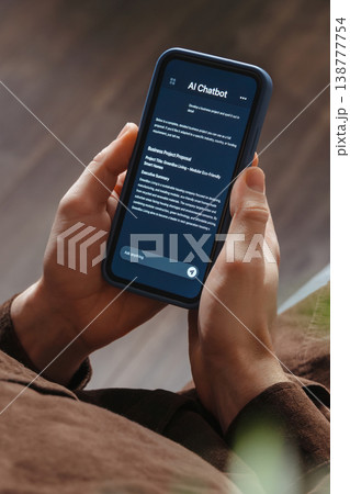 Man Using AI Chatbot App on Smartphone Man Using AI Chatbot App on Smartphone 138777754