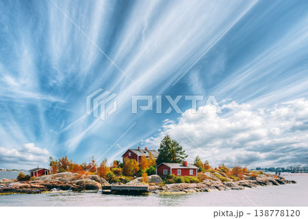 Small Red Cabin on a Rocky Island Small Red Cabin on a Rocky Island 138778120