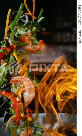 Freeze Motion of Flying Asian Meal with Vegetable and Prawns into Wok Pan Freeze Motion of Flying Asian Meal with Vegetable and Prawns into Wok Pan 138779691