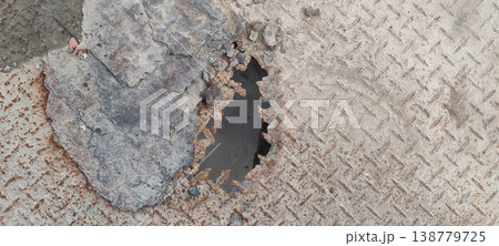 Rusty iron sheet with visible hole caused by water exposure and long term moisture corrosion damage Rusty iron sheet with visible hole caused by water exposure and long term moisture corrosion damage 138779725