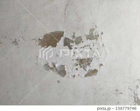 Wall surface with peeling paint and exposed plaster caused by water seepage damage indoors Wall surface with peeling paint and exposed plaster caused by water seepage damage indoors 138779746