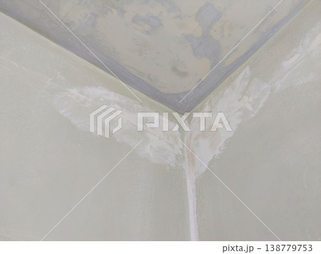 Wall corner putty application after sanding old paint preparing surface before final color 138779753