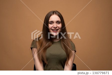 Young woman laughing, showing joy and positive emotion in a casual outfit. Expressing happiness and cheerfulness 138779871