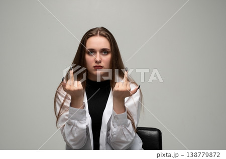 Young woman showing middle fingers with serious expression, expressing anger, frustration, and defiance 138779872