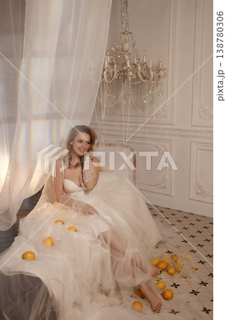 Beautiful Bride Smiling In Soft Morning Glow Amidst Scattered Lemons And Delicate Tulle Veil 138780306