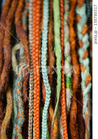 Colorful braid extensions texture background with mixed natural strands Colorful braid extensions texture background with mixed natural strands 138780317