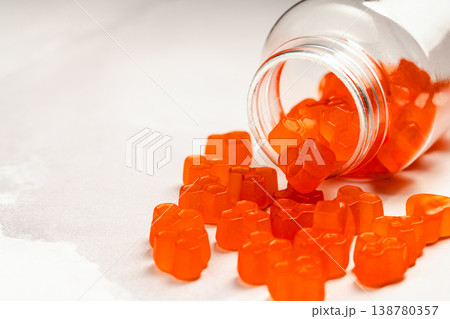 Jelly gummies close-up, fruit vitamins on bright background, food supplements.Orange vitamins in a jar, copy space Jelly gummies close-up, fruit vitamins on bright background, food supplements.Orange vitamins in a jar, copy space 138780357