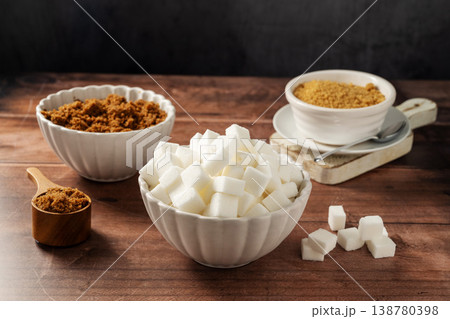 Different type of sugar. Light brown, dark brown and white sugar cubes in bowls. 138780398