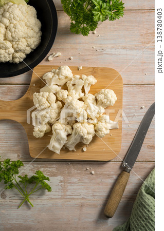 Female hands holding cauliflower lettuce pieces, cooking healthy vegetables Female hands holding cauliflower lettuce pieces, cooking healthy vegetables 138780403