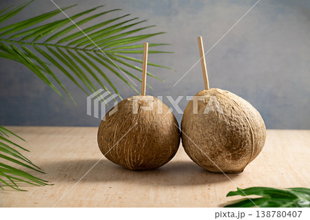 Fresh coconuts with straws, drinking coconut water Fresh coconuts with straws, drinking coconut water 138780407