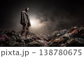 Young model standing on pile of discarded clothes highlighting fast fashion waste problem 138780675