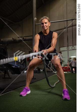 Fitness and health concept. A fit young woman works out in a modern gym. Athletic woman doing exercise. Fitness and health concept. A fit young woman works out in a modern gym. Athletic woman doing exercise. 138781260