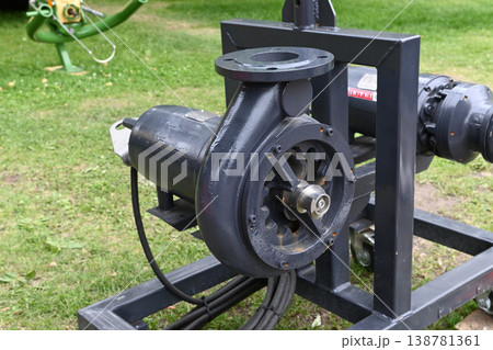 Working water pump on a green lawn with equipment Working water pump on a green lawn with equipment 138781361
