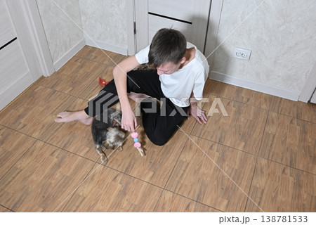 young bearded man with a dalmatian dog against white brick wall background 138781533