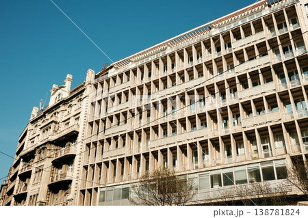 Facade of modern residential building with geometric pattern and balconies under clear blue sky. Concept of architecture, urban development and city lifestyle 138781824