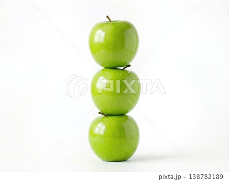 Geometric Stack of Three Different Green Apples with Stems Isolated on a Solid White Background 138782189