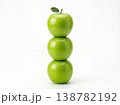 Geometric Stack of Three Different Green Apples with Stems Isolated on a Solid White Background 138782192