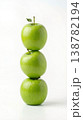 Geometric Stack of Three Different Green Apples with Stems Isolated on a Solid White Background 138782194