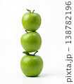 Geometric Stack of Three Different Green Apples with Stems Isolated on a Solid White Background 138782196