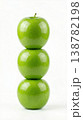 Geometric Stack of Three Different Green Apples with Stems Isolated on a Solid White Background 138782198