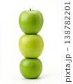Geometric Stack of Three Different Green Apples with Stems Isolated on a Solid White Background 138782201