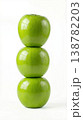 Geometric Stack of Three Different Green Apples with Stems Isolated on a Solid White Background 138782203