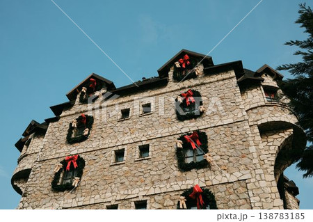 Stone hotel building decorated with red hearts and wreaths in Stanisici Ethno Village near Bijeljina Bosnia and Herzegovina. Concept of tourism architecture hospitality and romantic travel 138783185