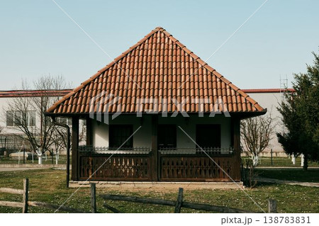 Traditional rural house with wooden porch and red clay tile roof in Balkans, Bosnia. Concept of countryside architecture, rural housing and traditional Balkan lifestyle 138783831