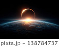 A solar eclipse takes place as the sun partially covers the Earth. Light shines from the horizon as the scene is dark 138784737