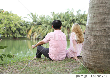 Low Angle Perspective of Asian Couple by Park Lake Low Angle Perspective of Asian Couple by Park Lake 138784765