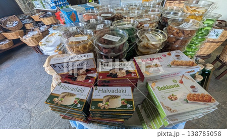 Boxes of Greek sweets and containers with various dried fruits in a gourmet gift shop Boxes of Greek sweets and containers with various dried fruits in a gourmet gift shop 138785058