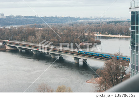 Aerial Kyiv landmark, Ukraine. Spring Kyiv landscape with metro bridge. Urban landscape on cloudy day. Windy and rainy day in Ukraine. Spring in Ukrainian capital. Underground bridge over the river 138786558