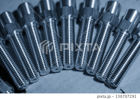 A creative arrangement of metal screws organized in a half-circle shape on a blue-toned industrial background. A creative arrangement of metal screws organized in a half-circle shape on a blue-toned industrial background. 138787291