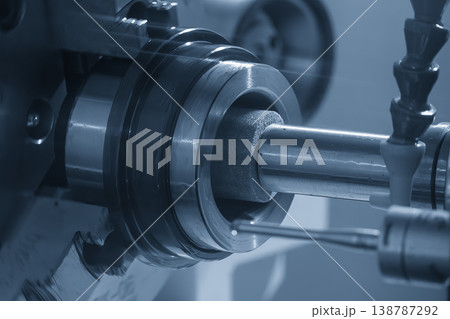 High-precision internal grinding process for hole surface finishing in a light blue industrial scene. 138787292