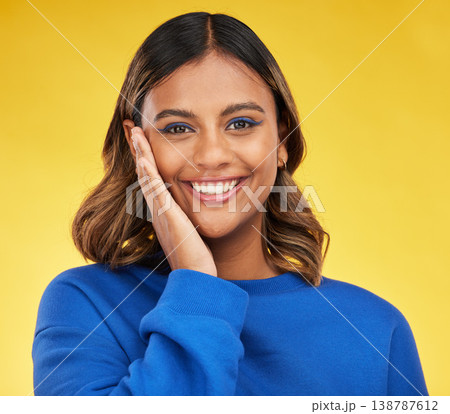 Portrait, smile and skincare with a woman on a yellow background in studio for fashion or cosmetics. Face, makeup and a happy young female model posing indoor in a trendy outfit for clothes style 138787612