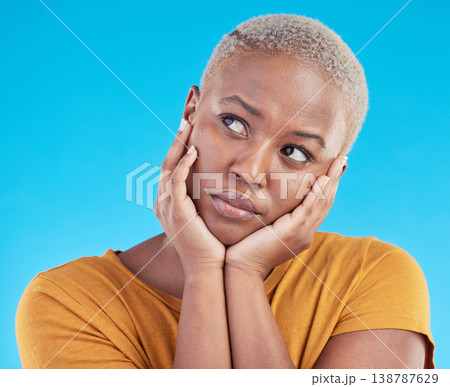 Thinking, sad and black woman with depression, decision or solution on a blue studio background. Person, alone or model with problem solving, thoughts or anxiety with mental health, unhappy or choice 138787629