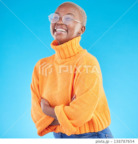 Thinking, happy and black woman with glasses, arms crossed and studio isolated on a blue background. Excited, confident nerd and African geek smile for fashion, style and person in casual clothes 138787654