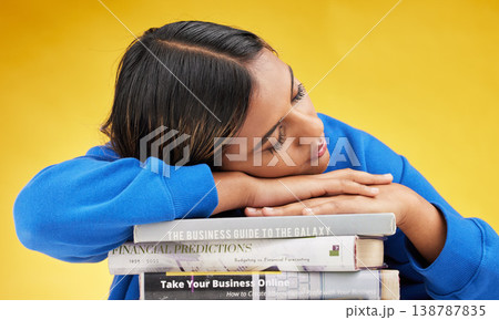 Woman, student and sleeping with books in studio with burnout, financial education and tired by yellow background. Gen z girl, learning and studying business with fatigue, knowledge and development Woman, student and sleeping with books in studio with burnout, financial education and tired by yellow background. Gen z girl, learning and studying business with fatigue, knowledge and development 138787835
