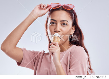 Fashion, ice cream and portrait of woman with cone in studio with dessert, snack and sweet treats. Happy, fashion and face of female person with sunglasses in trendy accessories, style and cosmetics Fashion, ice cream and portrait of woman with cone in studio with dessert, snack and sweet treats. Happy, fashion and face of female person with sunglasses in trendy accessories, style and cosmetics 138787983