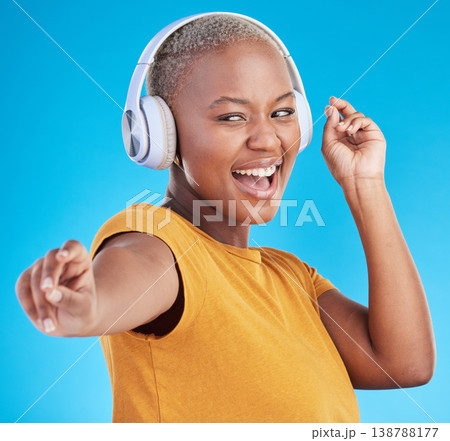 Black woman, headphones and dance, listen to music and energy with happiness isolated on blue background. Female person, wireless tech and radio with fun, dancer with freedom and streaming in studio Black woman, headphones and dance, listen to music and energy with happiness isolated on blue background. Female person, wireless tech and radio with fun, dancer with freedom and streaming in studio 138788177