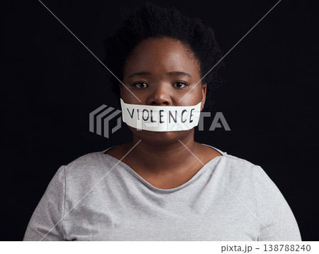 Portrait, censorship and a black woman in protest of domestic violence on a dark background. Freedom, gender equality or empowerment with a serious young female person in studio for human rights Portrait, censorship and a black woman in protest of domestic violence on a dark background. Freedom, gender equality or empowerment with a serious young female person in studio for human rights 138788240
