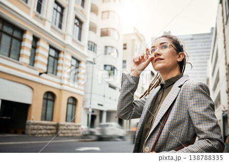 Corporate woman in city, travel and commute to work with buildings, motion blur and waiting for taxi cab. Professional female person in urban street, business clothes and journey to workplace 138788335