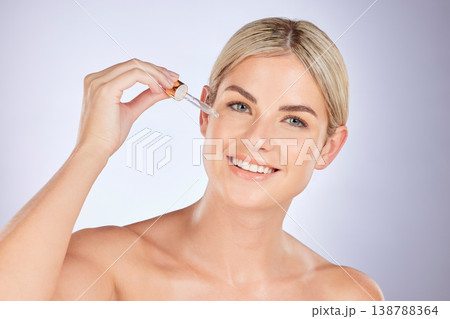 Skincare, oil and portrait of woman in studio for liquid, application and dermatology treatment on grey background. Face, serum and female wellness model with vitamin c, retinol or hyaluronic acid 138788364