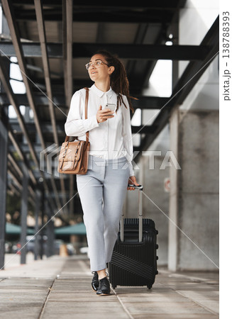 Phone, travel and suitcase with a business woman in an airport parking lot walking outdoor in the city. Mobile, luggage and commute with a young corporate professional on an international work trip 138788393