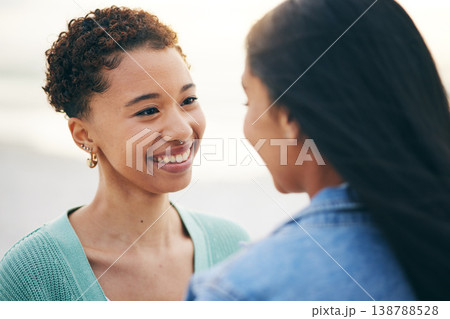 Sunset, beach and lesbian couple with love and smile together on an outdoor vacation or holiday for romance. Lgbtq, pride and women bonding on a summer date for adventure, relax and happiness Sunset, beach and lesbian couple with love and smile together on an outdoor vacation or holiday for romance. Lgbtq, pride and women bonding on a summer date for adventure, relax and happiness 138788528