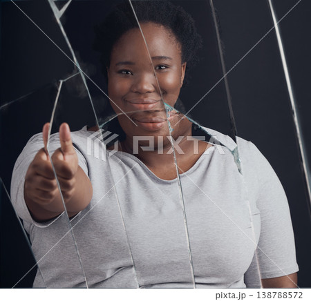 Healing, success and woman portrait with thumbs up in broken mirror after depression and stress in studio. Face, smile and African female abuse survivor emoji hand for feedback on bipolar treatment Healing, success and woman portrait with thumbs up in broken mirror after depression and stress in studio. Face, smile and African female abuse survivor emoji hand for feedback on bipolar treatment 138788572