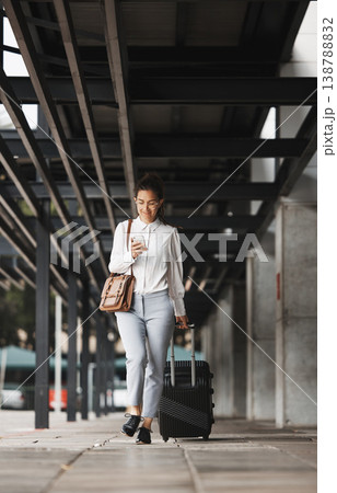 Phone, travel and luggage with a business woman in an airport parking lot walking outdoor in the city. Mobile, suitcase and commute with a young corporate employee on an international trip for work Phone, travel and luggage with a business woman in an airport parking lot walking outdoor in the city. Mobile, suitcase and commute with a young corporate employee on an international trip for work 138788832