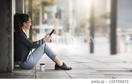 Phone, woman and coffee break in the city, street or job search, employment or network on social media, internet or online. Unemployed, worker sitting and reading news or wanted ads on cellphone 138788872